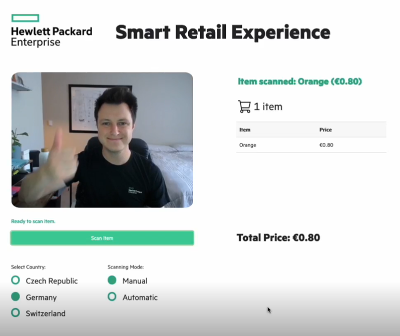 The end result of this blog shows the model identifying the orange and charging the customer in the checkout basket. This pictures shows the end result of the ML model and webcam simplifying a retail checkout process by identifying and placing the cost of an orange in the customer's virtual basket.